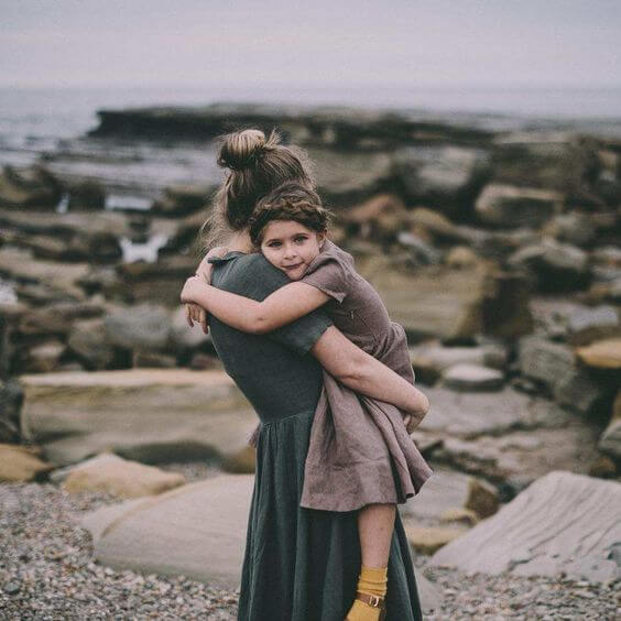 Mom holding daughter