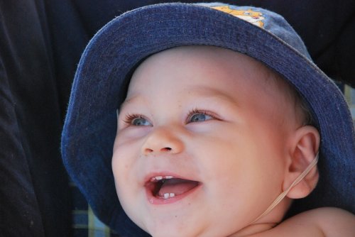 baby showing his first teeth coming in