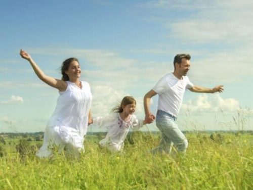 Family running in a meadow