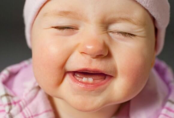 Baby smiling with baby teeth