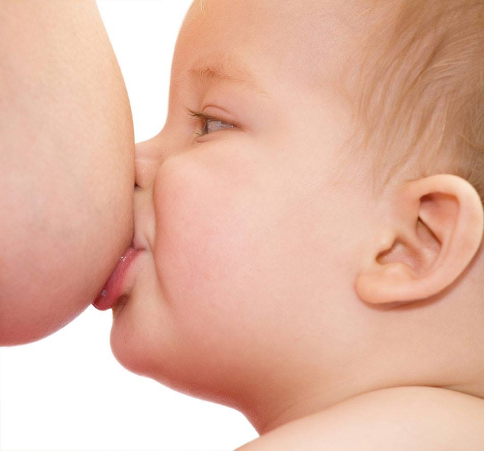 Baby latching on to mother's nipple