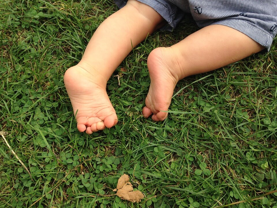 Child barefoot on grass
