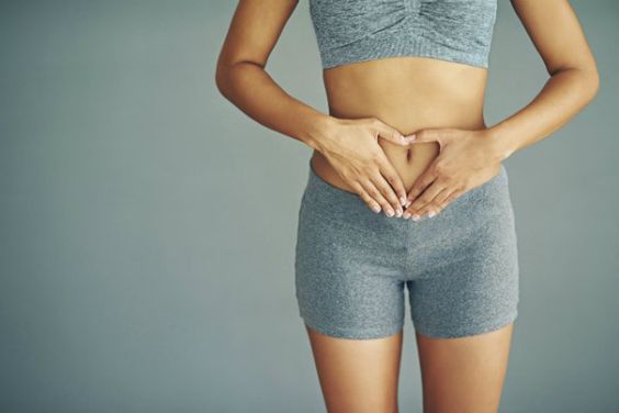 woman holding lower abdomen