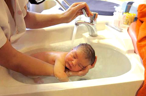 Baby being bathed