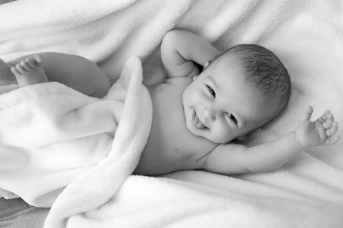 Black and white photo of baby smiling