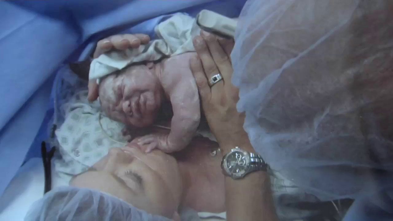 Mother holding newborn baby in hospital