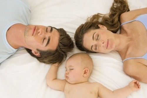 mom, dad and baby sleeping