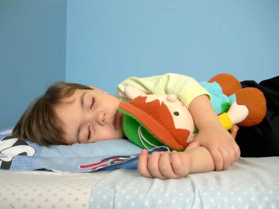 boy sleeping with stuffed animal