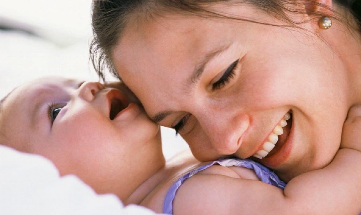 mom smiling with baby