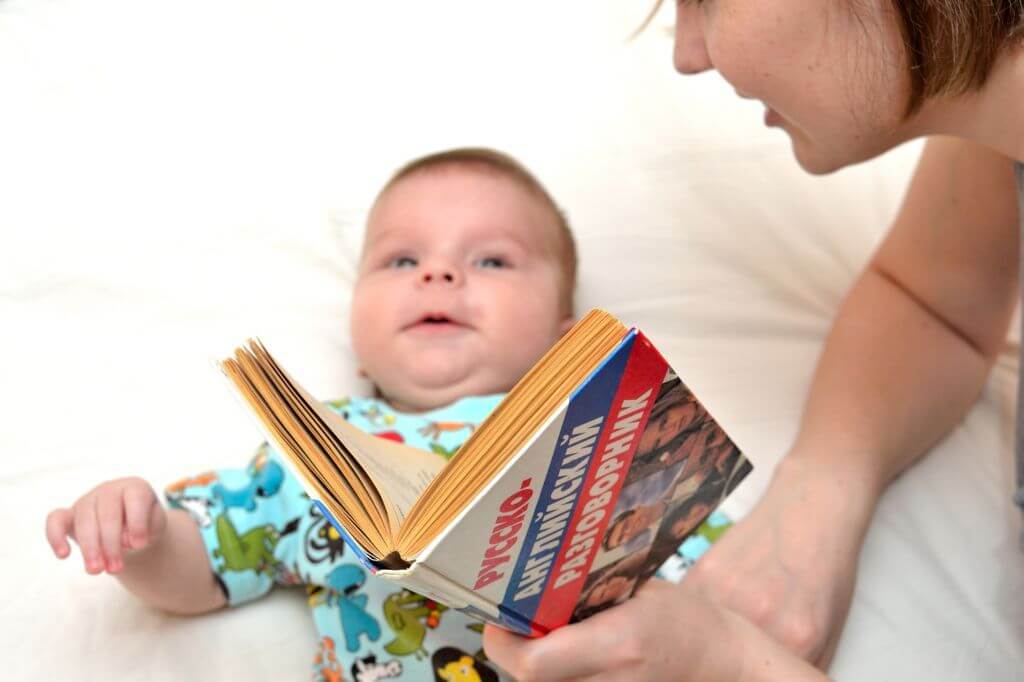 mom reading to baby