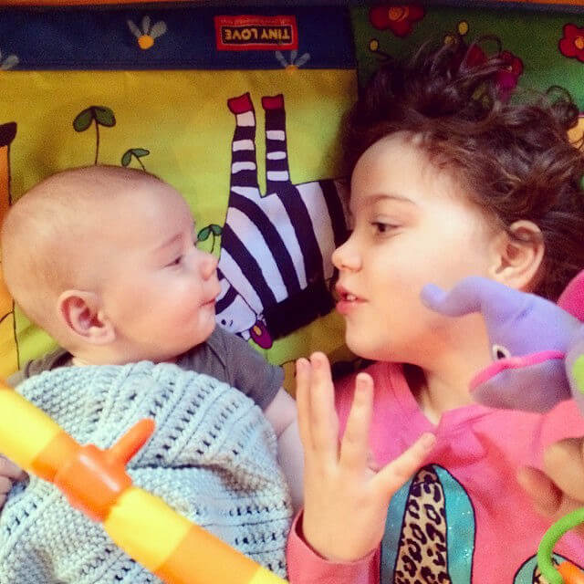 baby and older sister playing
