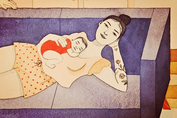 mom holding baby on the sofa