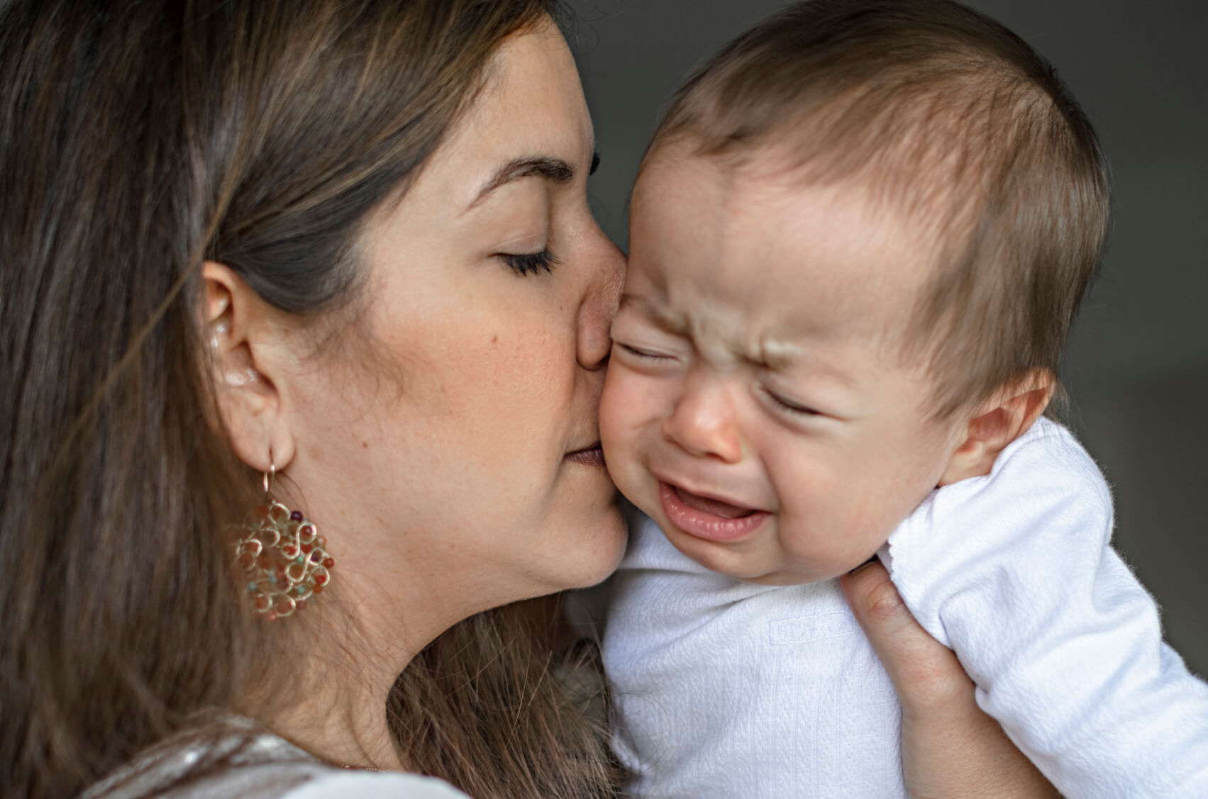 Mom kissing baby