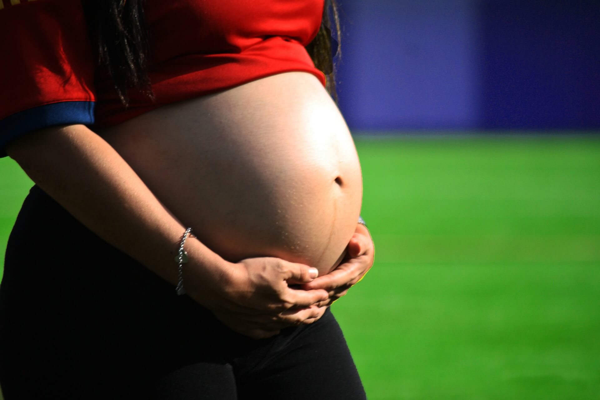 pregnant woman holding her belly