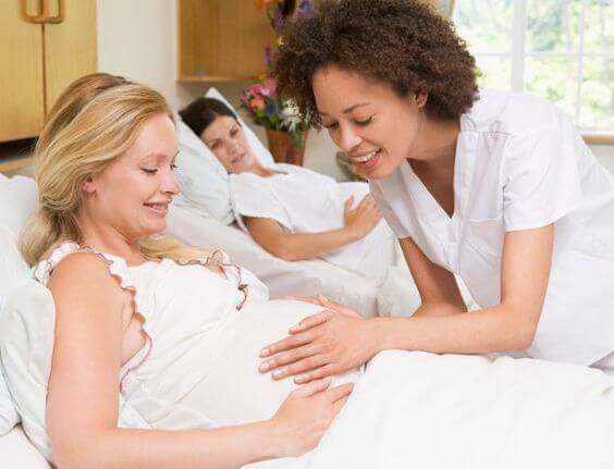 Pregnant woman in hospital being taken care of