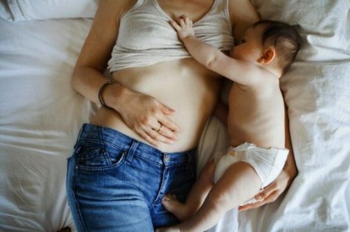 mom breastfeeding her baby in bed
