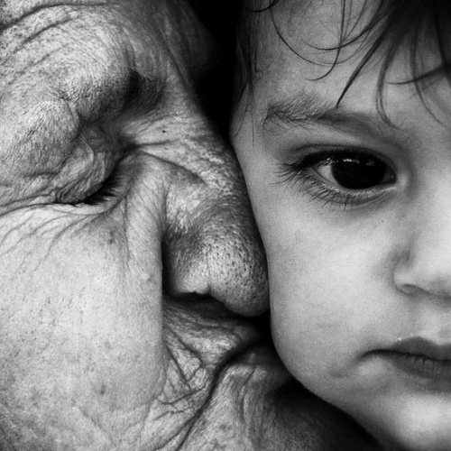 grandmother kissing grandson