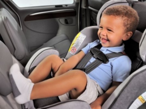 child in car seat without a coat on