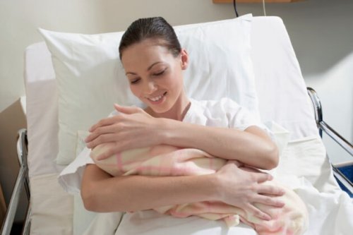 mother holding newborn baby in the hospital