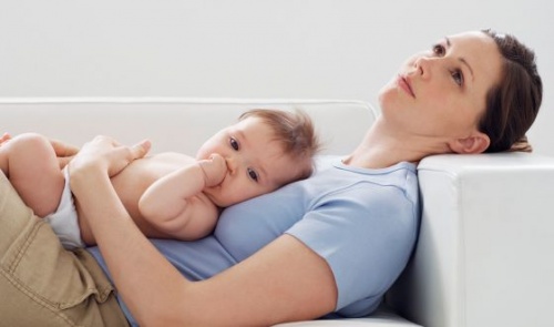 mom and baby lying on the couch