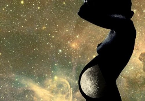silhouette of pregnant woman with the moon in her belly