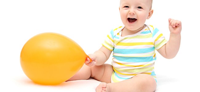 baby sitting on the floor with a balloon
