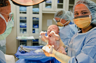 doctor holding newborn baby