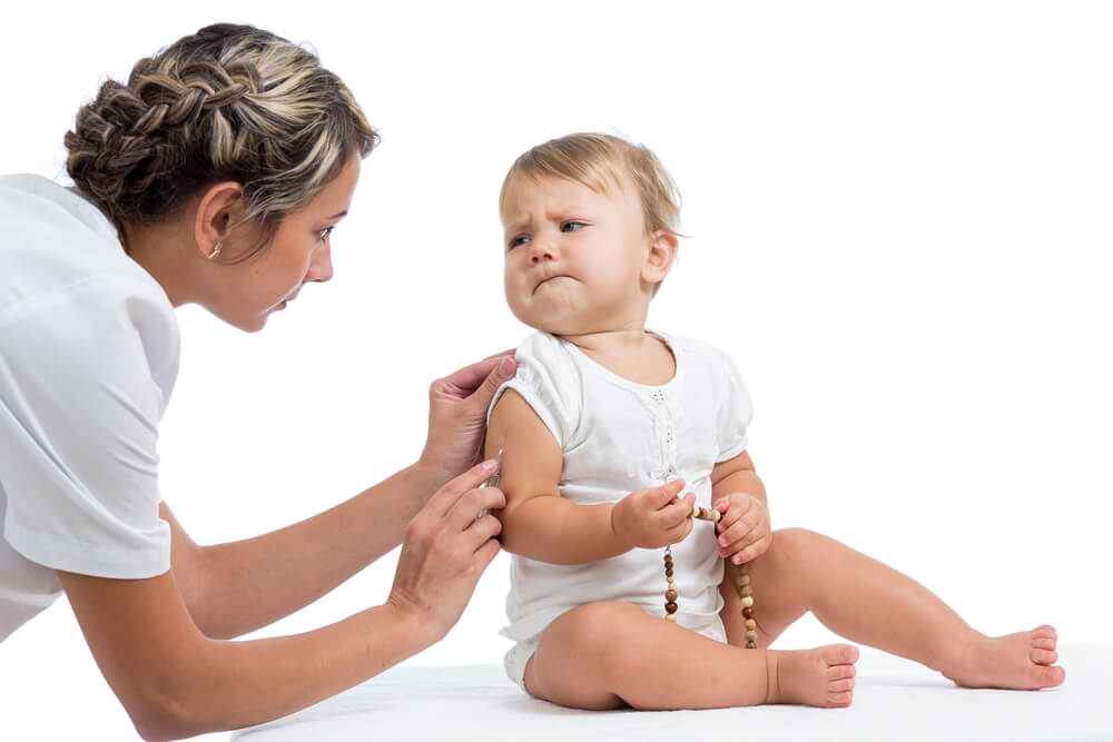 baby getting vaccine from doctor