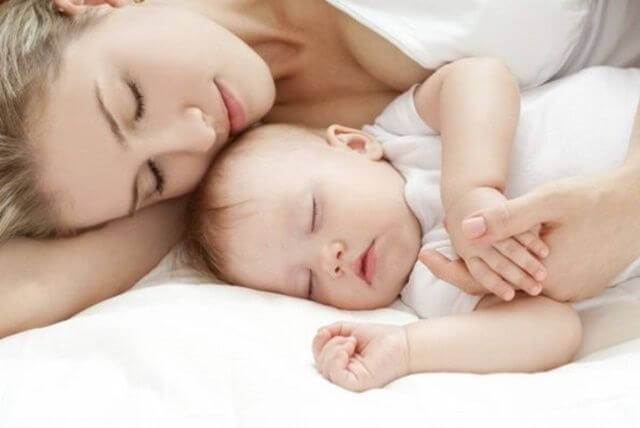 mother sleeping peacefully with baby
