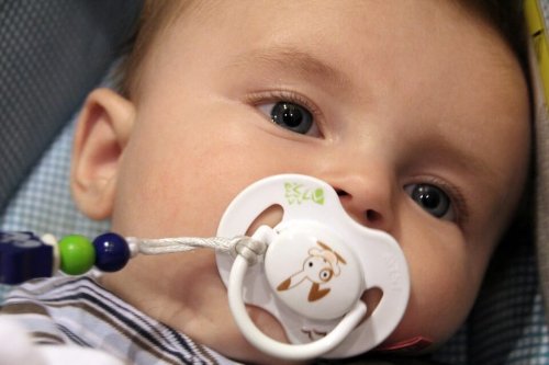 baby sucking on a pacifier