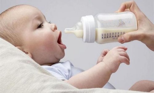 mom feeding baby with a bottle
