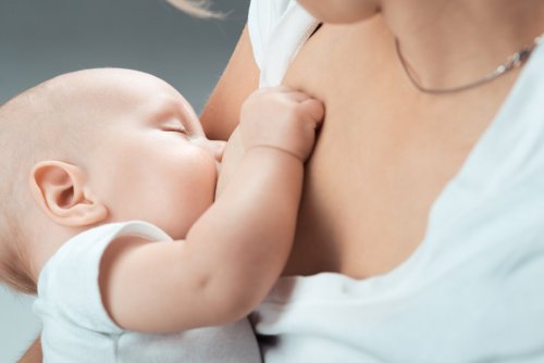 newborn baby being breastfed by mom