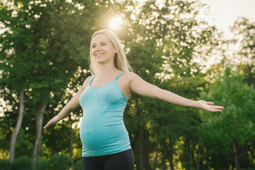 pregnant woman smiling out in nature