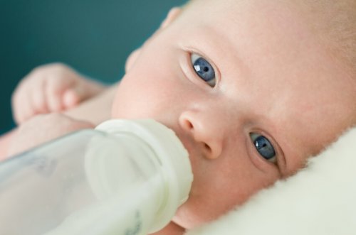 newborn drinking milk from a bottle