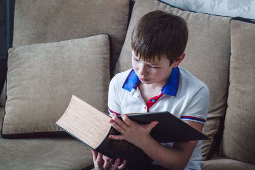 dreng der læser i en kæmpe bog