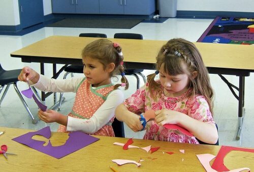 Children using paper to do crafts.