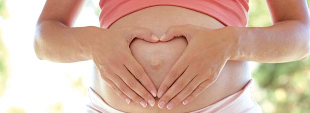 Pregnant woman, heart on tummy