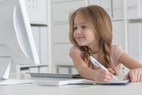 Child working on an assignment for her computer courses.