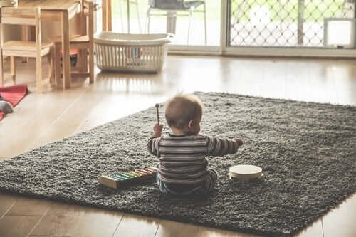 A baby playing instruments.
