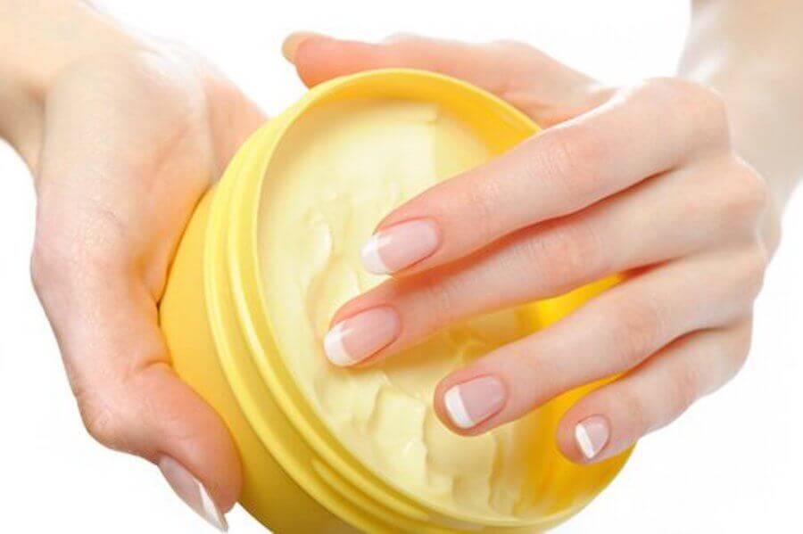 A woman with some hand cream.