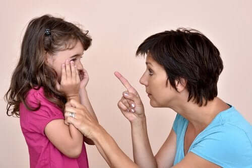 A mother scolding a crying child.
