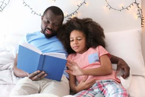 A father reading to his daughter.
