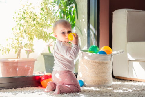 A baby playing with toys from a basket.