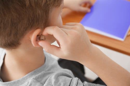 A boy wearing a hearing aid.