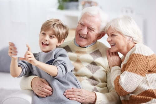 A child taking a selfie with his grandparents.