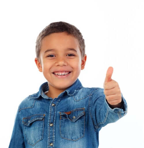 A boy giving a thumbs up.