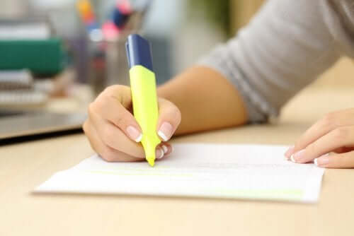 A student highlighting her notes.