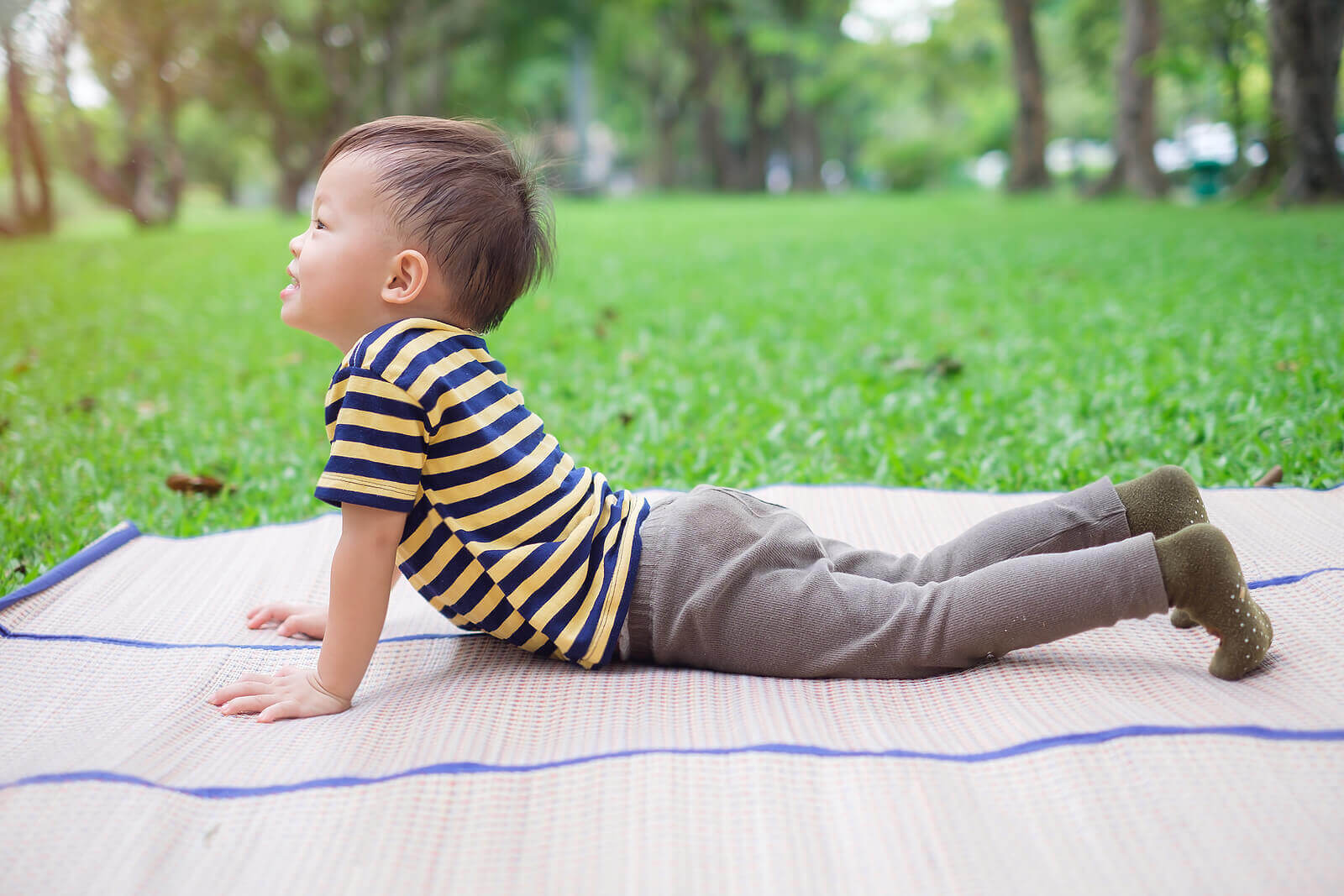 Child doing a cobra pose in yoga
