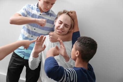 A student experiencing bullying at the hands of his classmates.