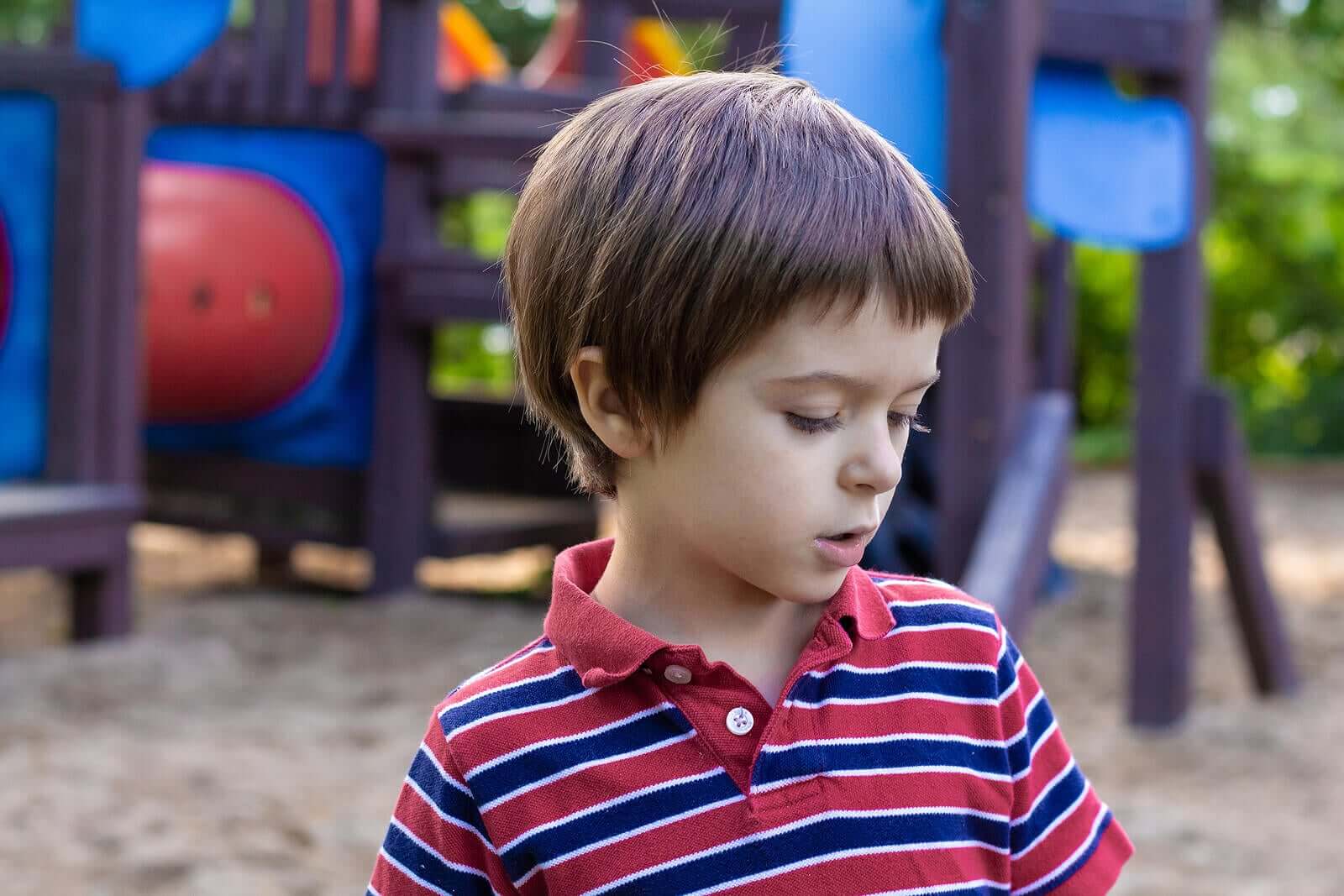 A child talking to himself on a playground.